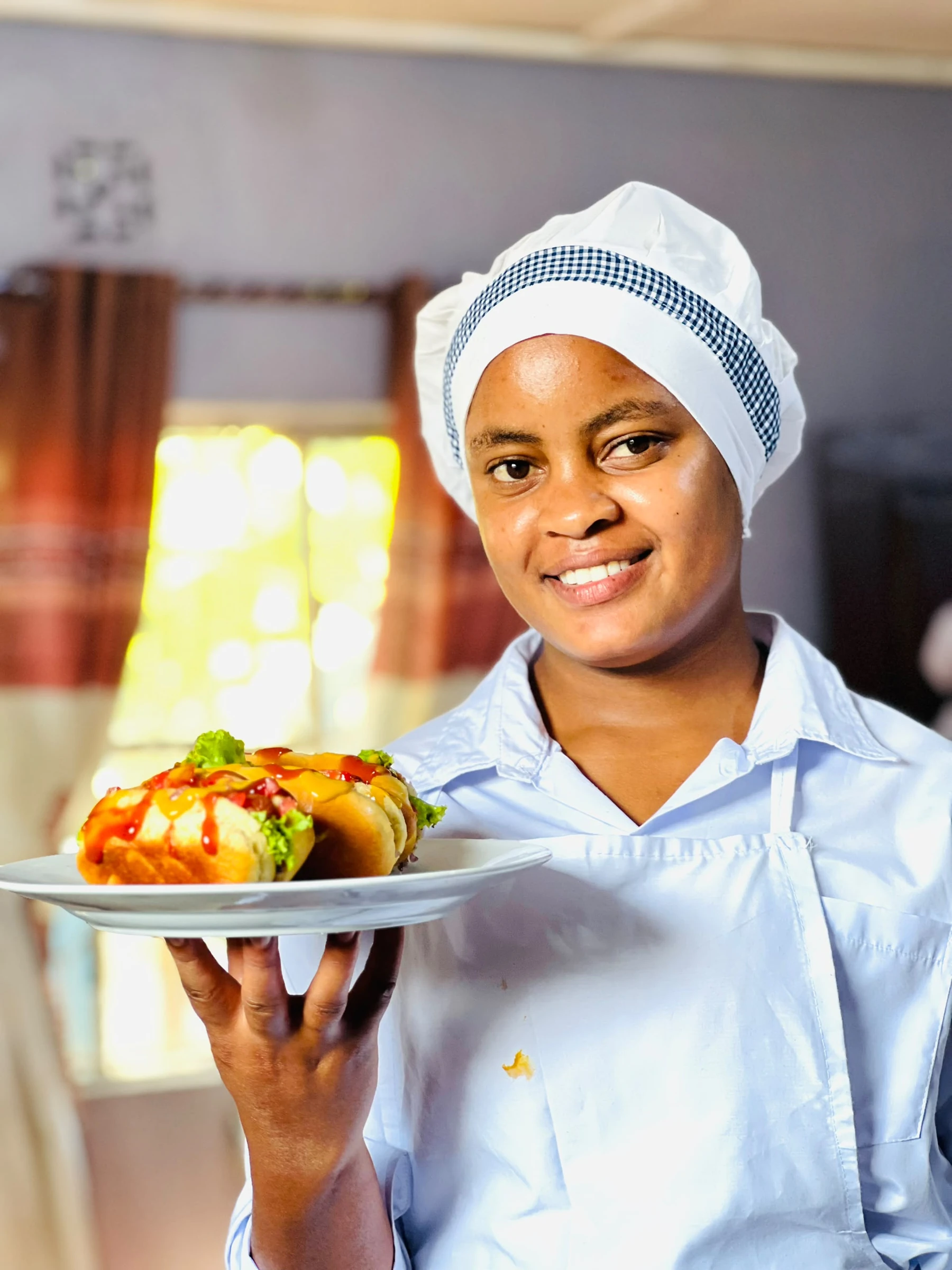Keepsake culinary student holding a plate of prepared food